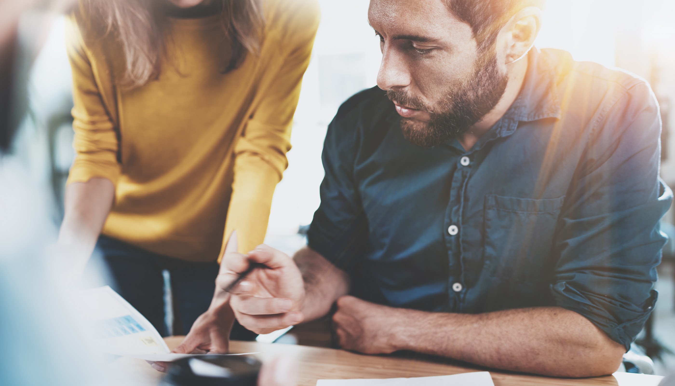 Teamwork concept.Business team sitting at meeting room and making conversations at office.Horizontal.Blurred background.Flare